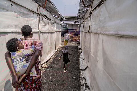 Mpox outbreak: A girl suffering from mpox walks past a treatment centre in Munigi